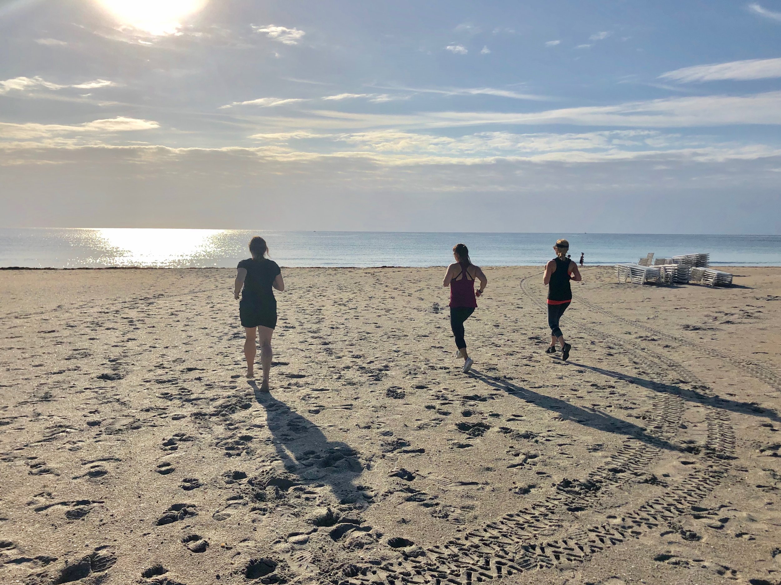 Running on the beach during fitness vacation.