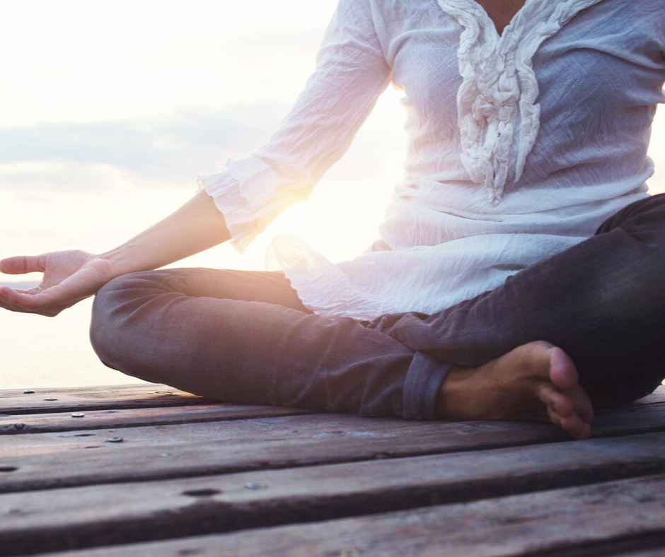 Woman practicing deep breathing as a grounding technique.