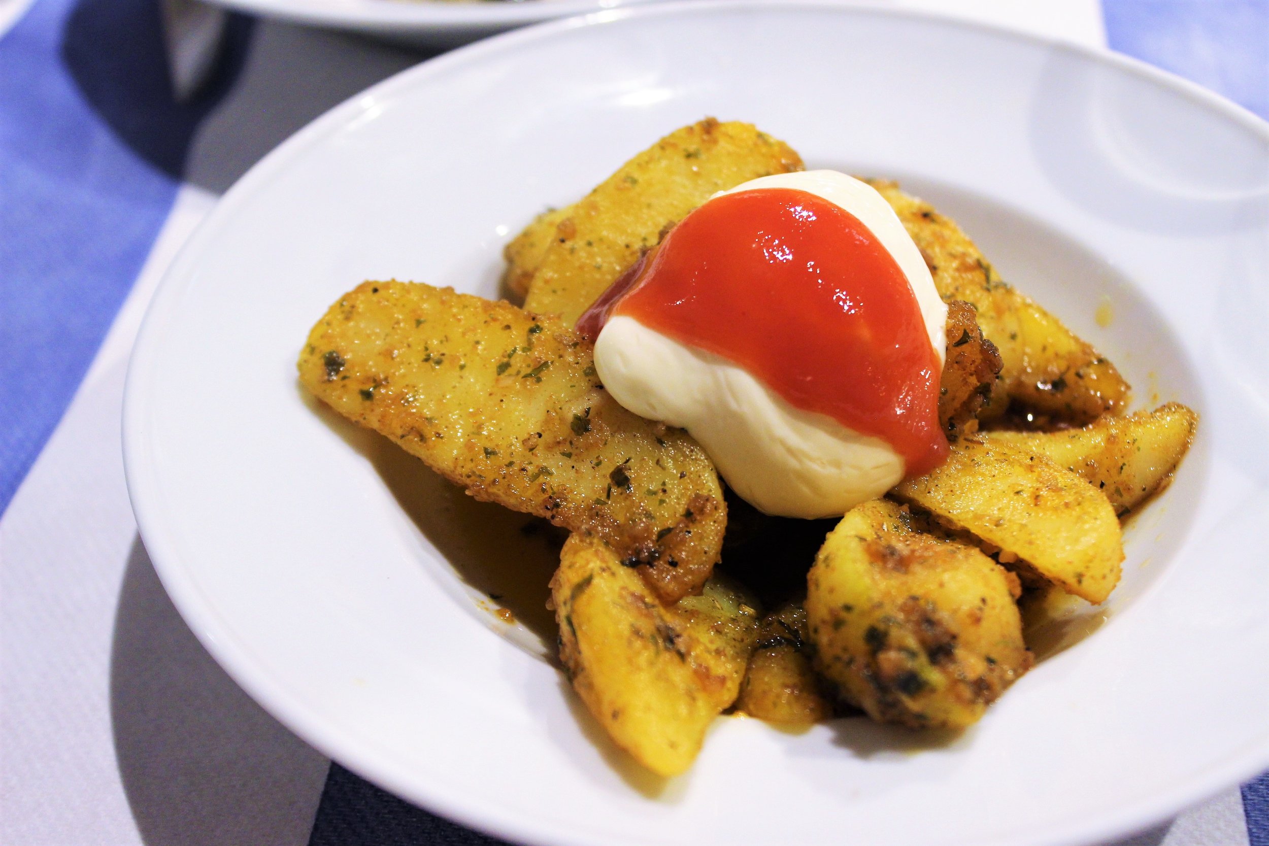 Spicy Potatoes with Mayonnaise and Salsa Brava at Gustos Bcn in Barcelona