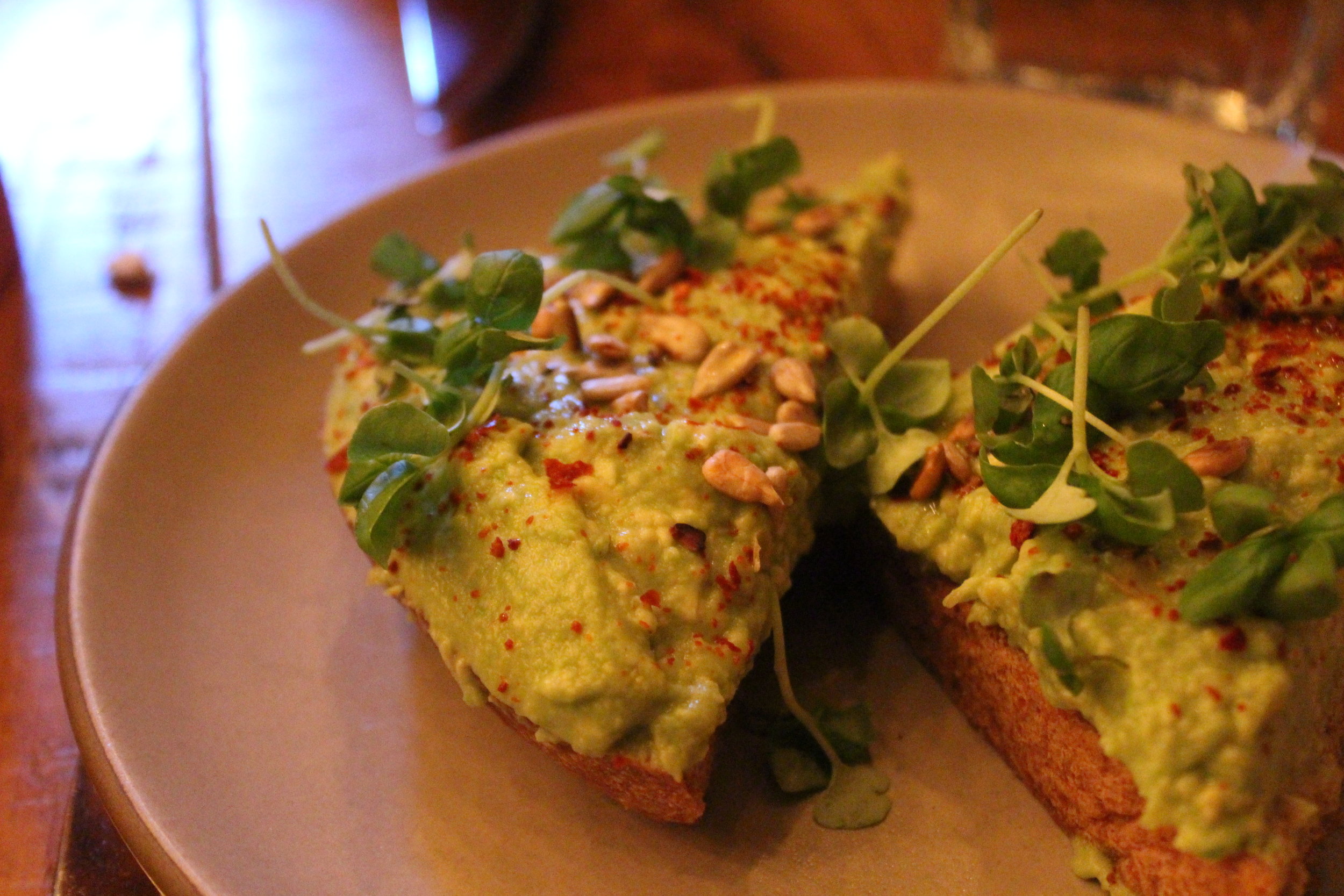 Avocado Toast (Homemade Wheat Bread, Aleppo Pepper, Lemon, Lebanese Olive Oil, Seeds and Sprouts, Basil)