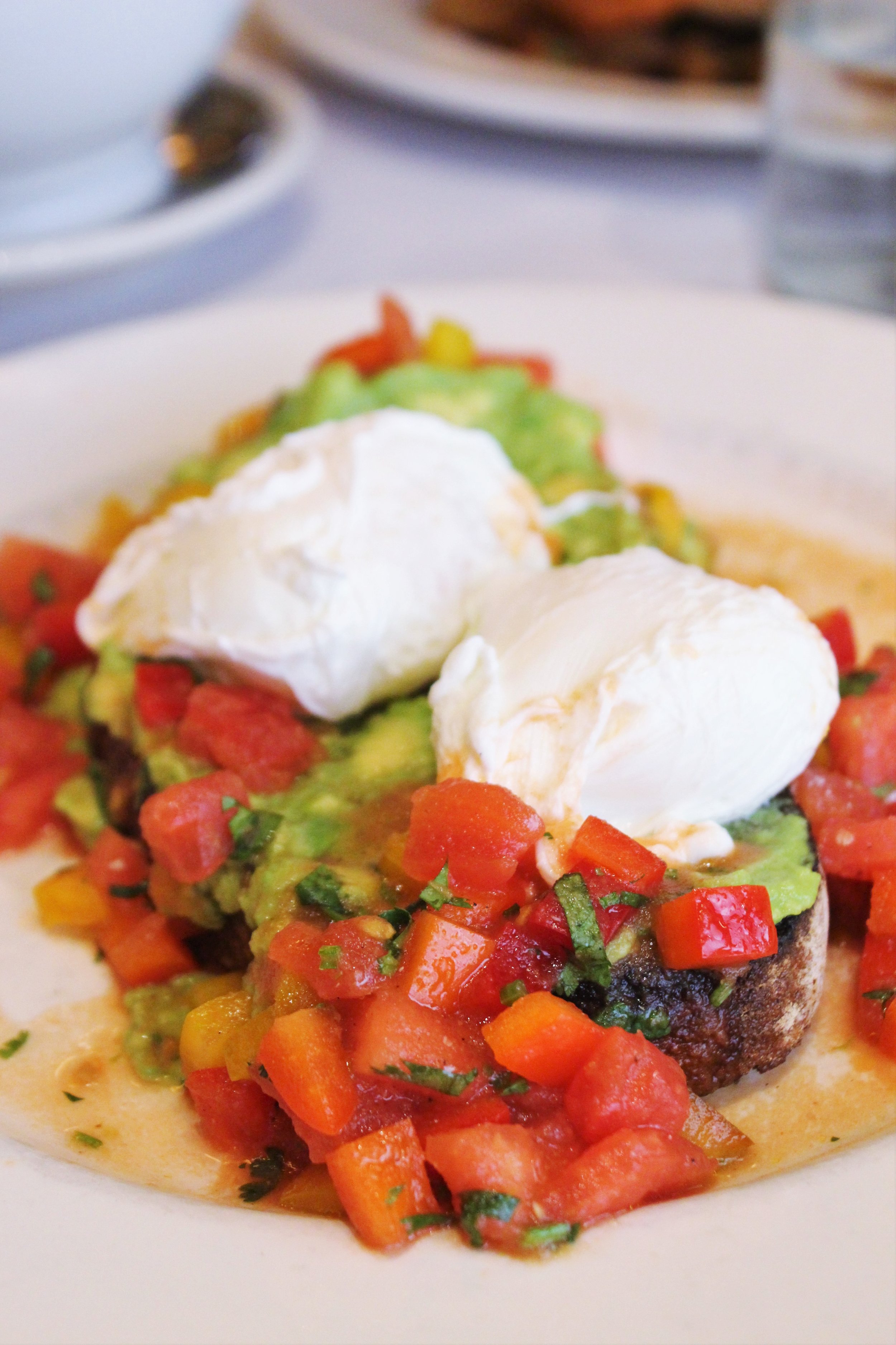 Avocado and Poached Eggs on Toast with tomato-jalapeño salsa 