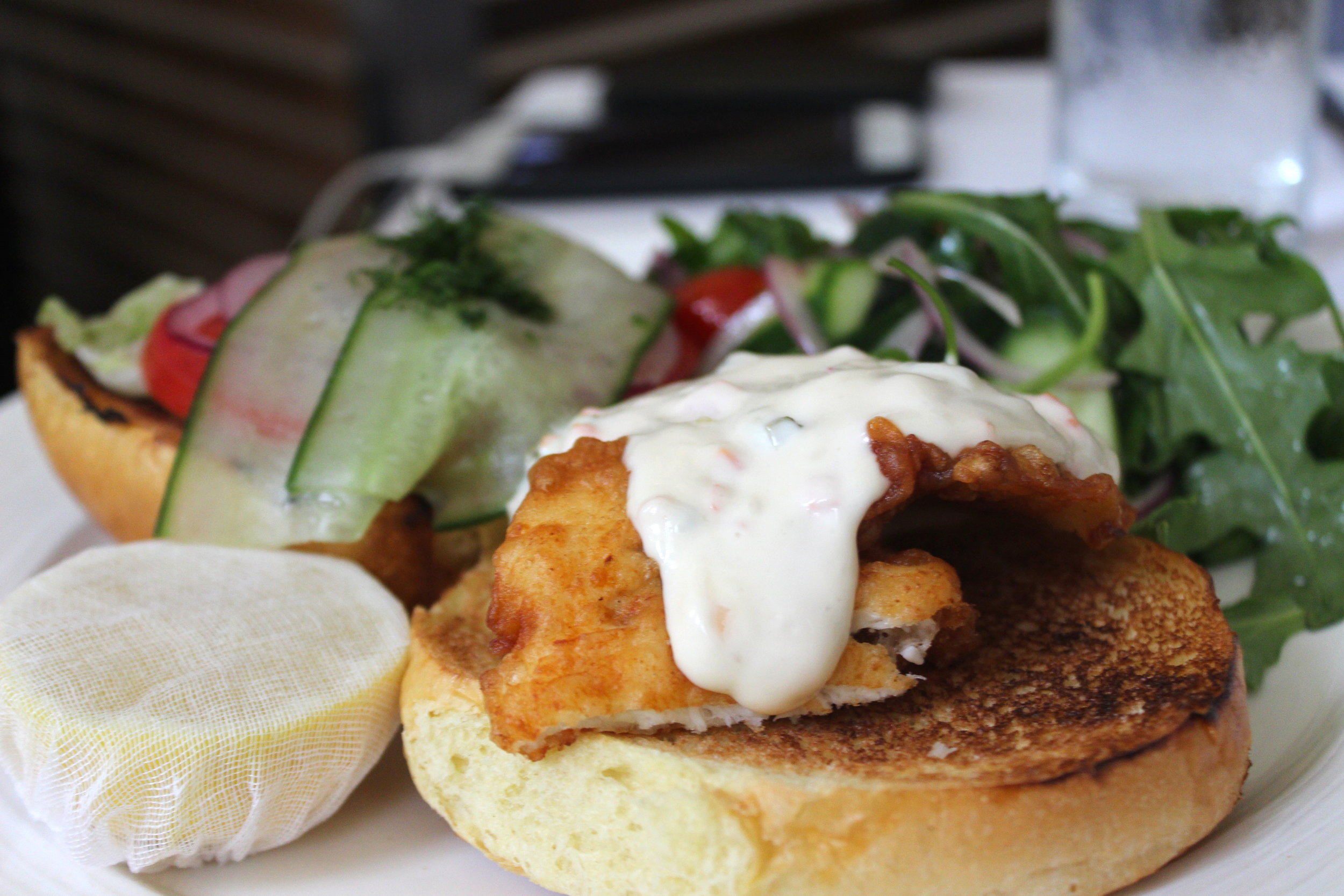 Fish Sandwich, beer battered, sliced red onions, and tzatziki tartar sauce