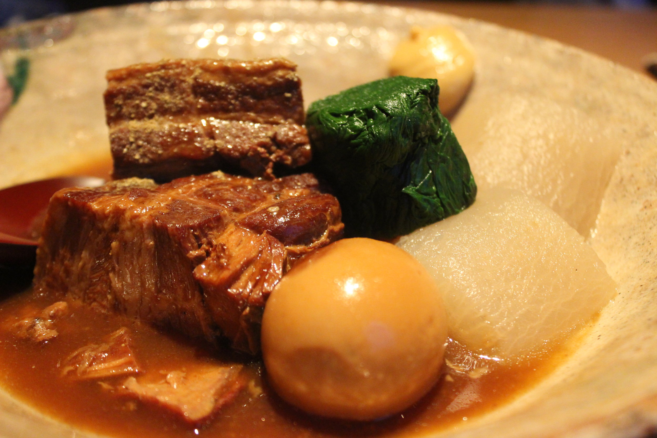 Kurobuta Kakuni: Braised Berkshire pork belly in sansho miso served with a hard boiled egg, spinach and daikon radish 