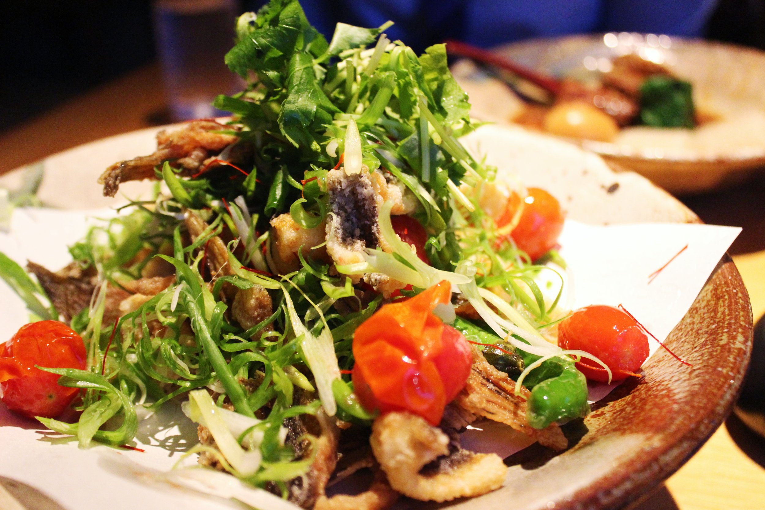 Karei Kara Age: Seasoned flounder fried with shishito peppers, tomato, scallions, and its bones, with a spicy ponzu sauce 