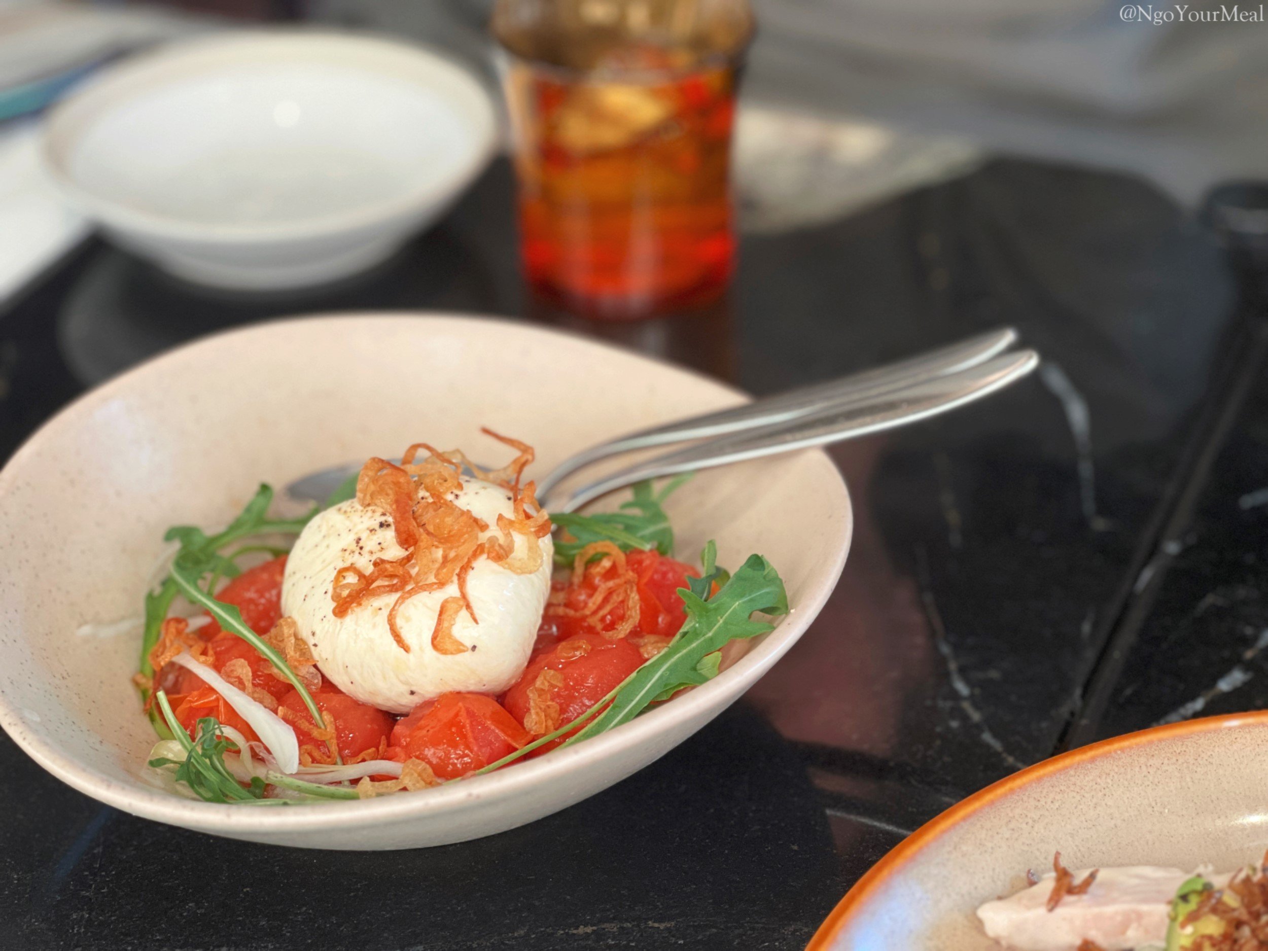 Burrata Caprese Salad: Burrata Cheese, Baked Tomatoes, Perilla Oil Vinaigrette 