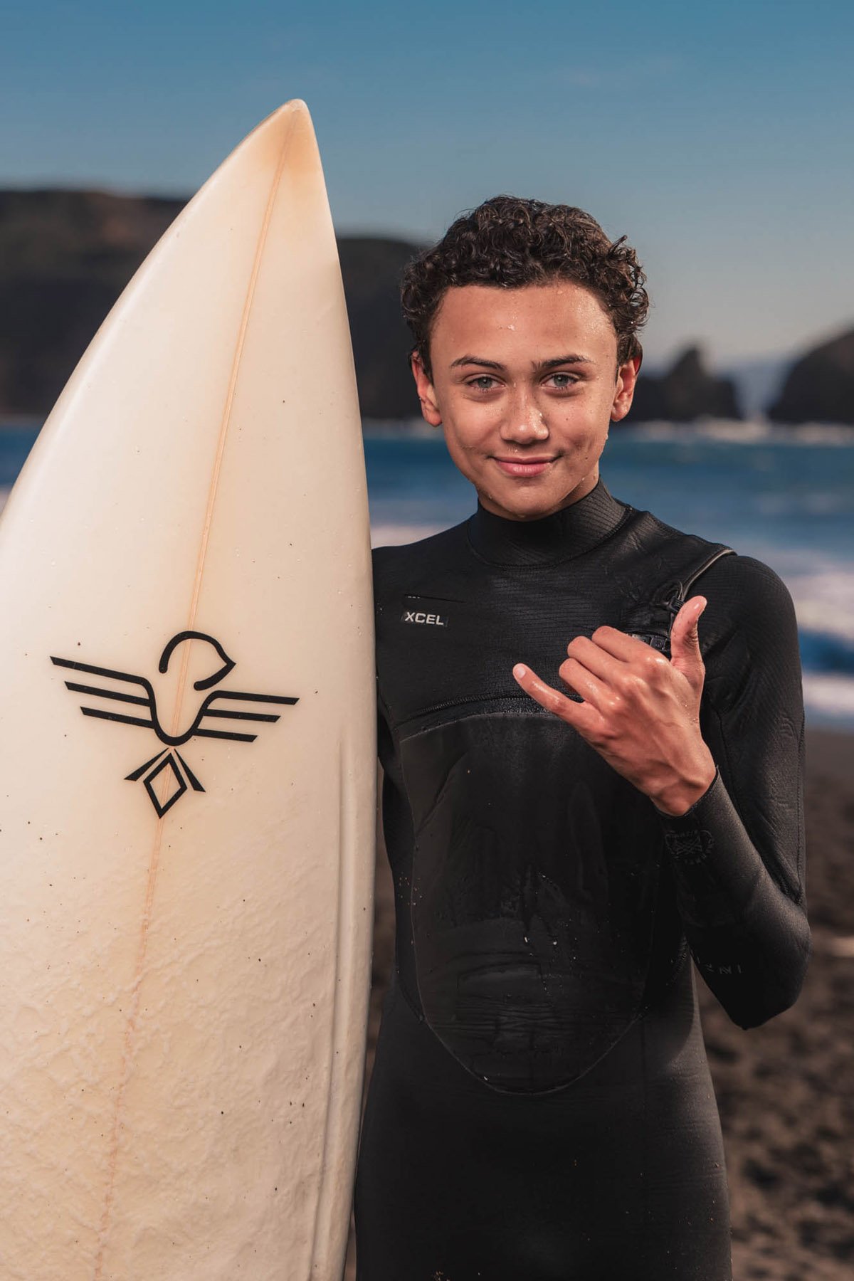 Young man with surfboard in california