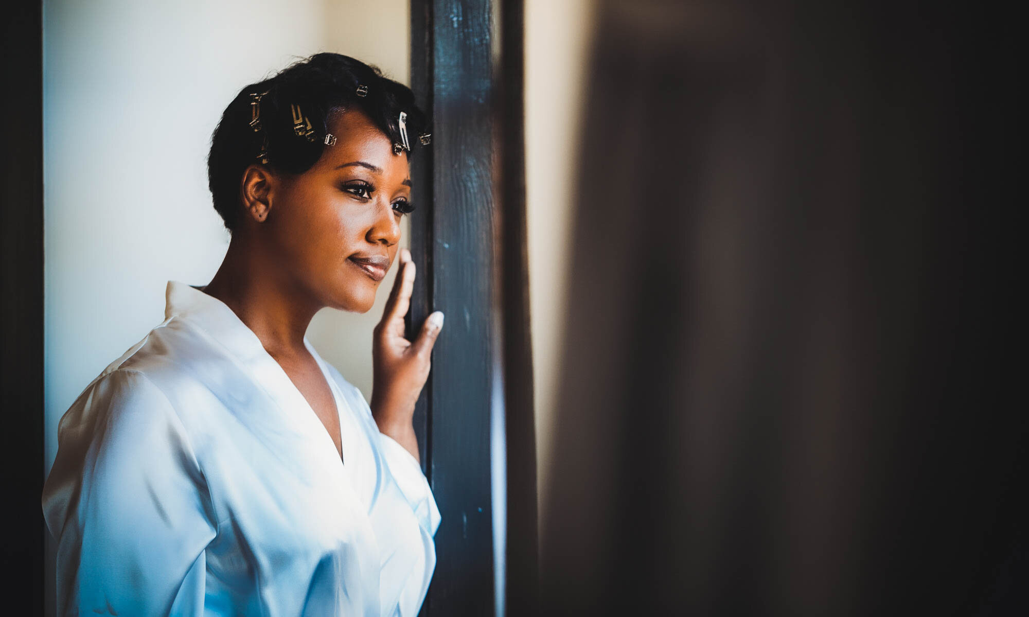 african american bride looking out window.jpg