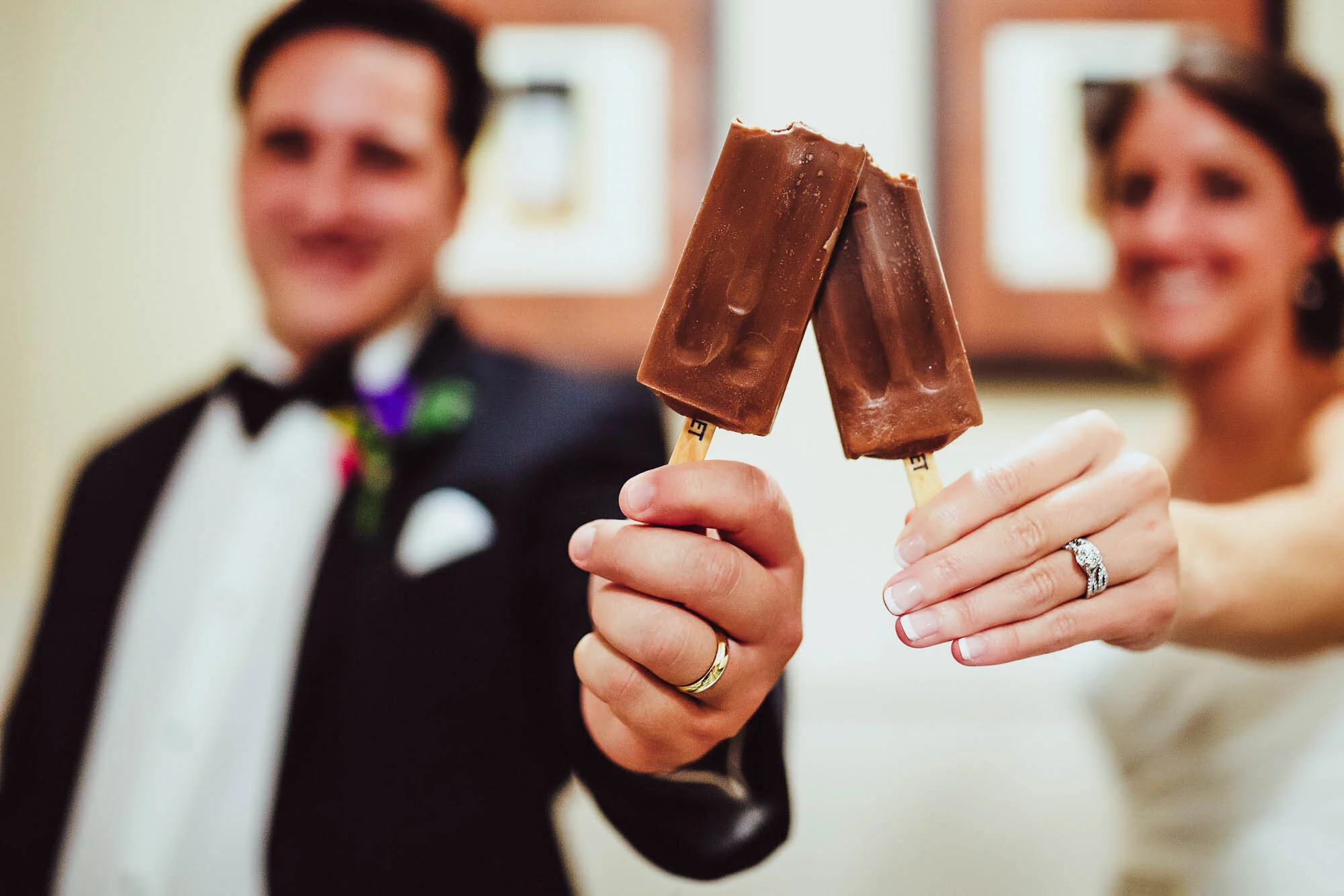 bride and groom holding popsickles.jpg