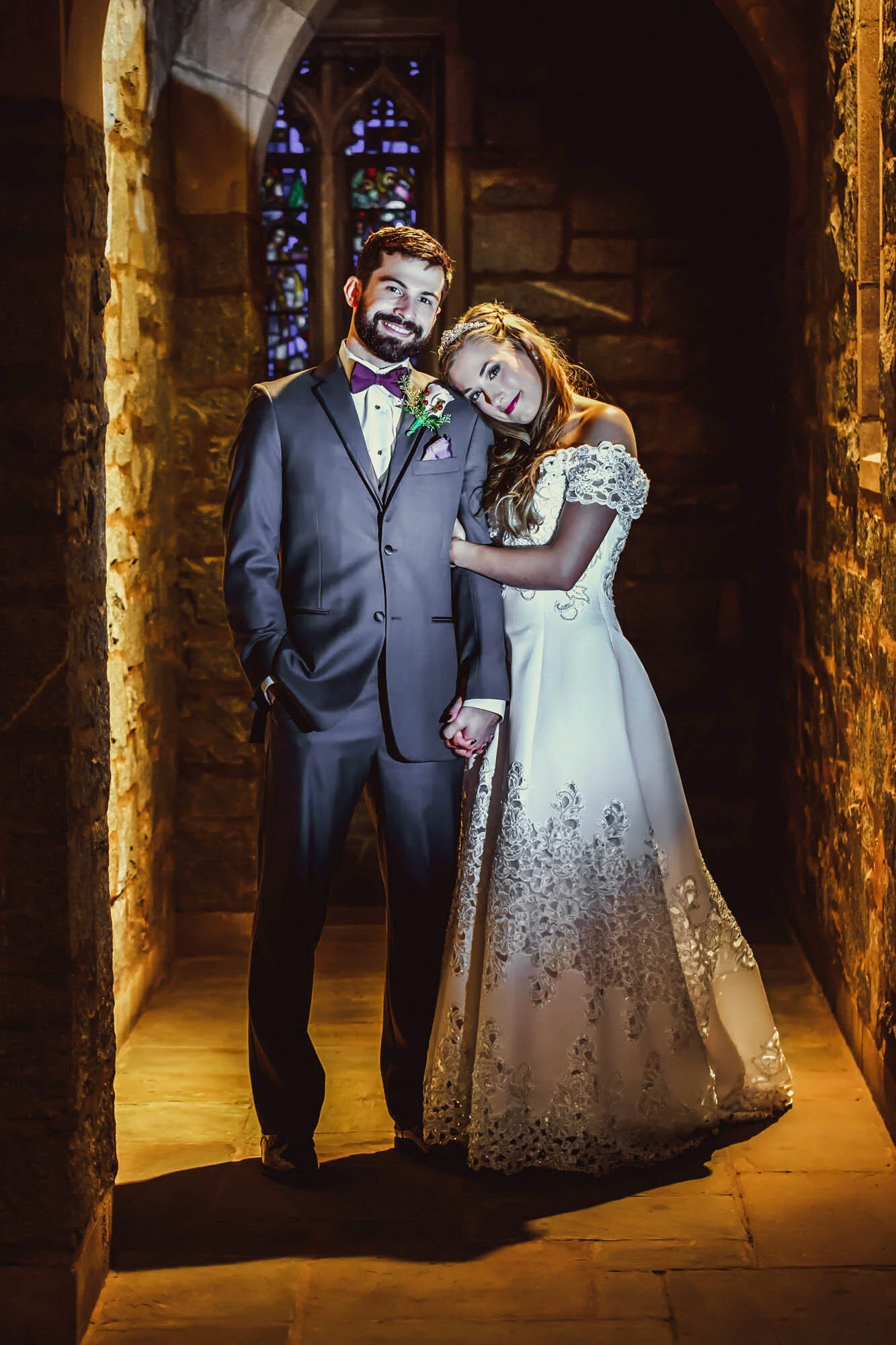 bride and groom psoing in hallway.jpg
