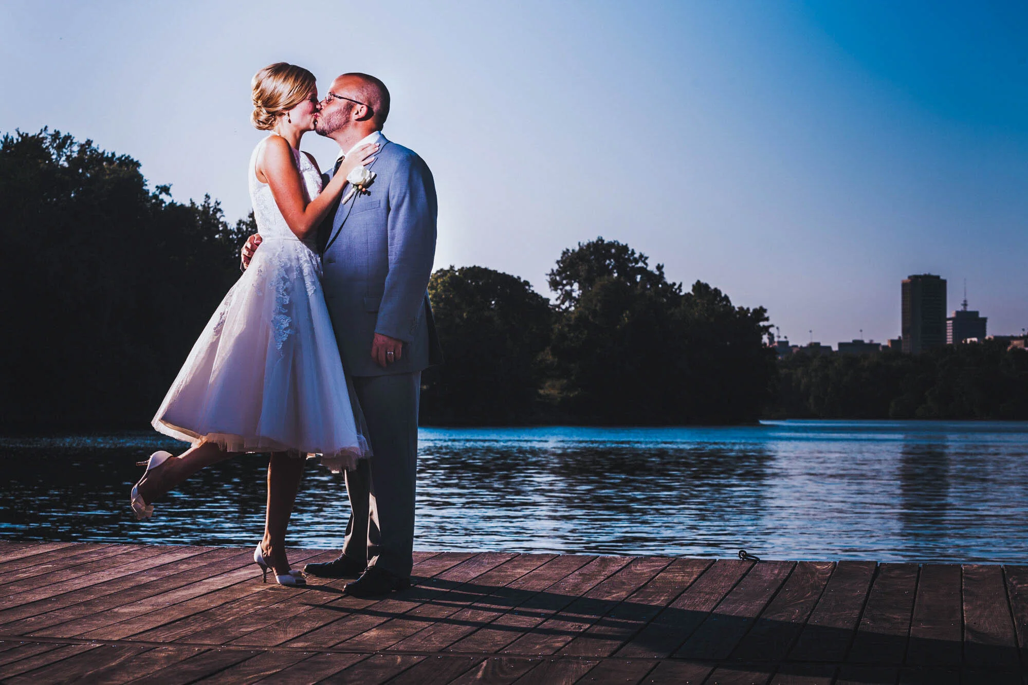 bride kissing groom by river.jpg