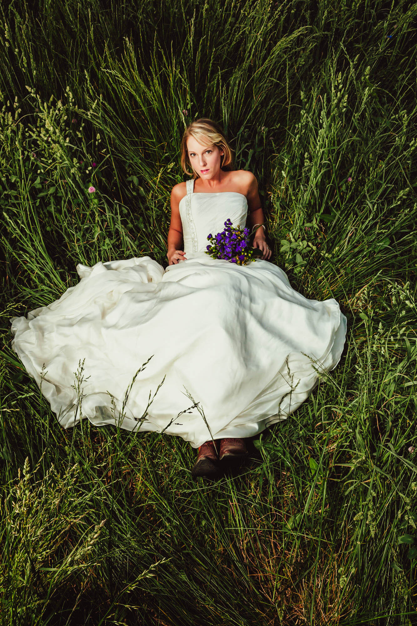 bride reclining in tall grass.jpg