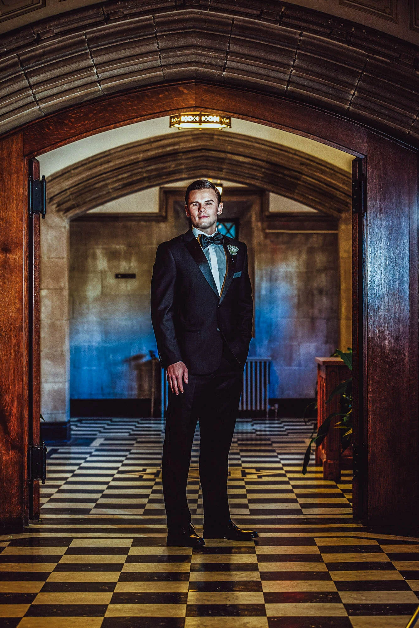 groom posing in church hallway.jpg