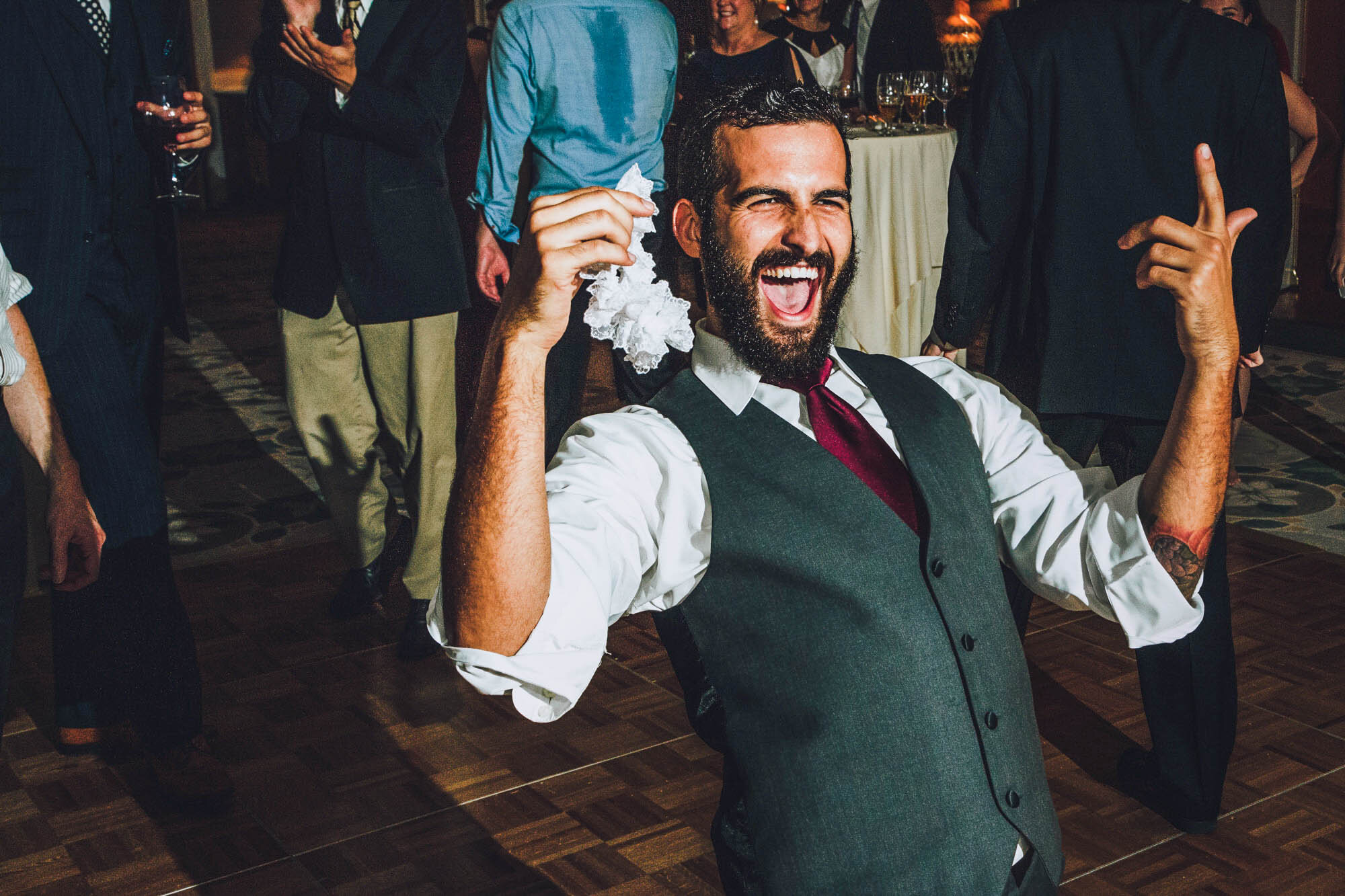 groomsmen catching garter.jpg