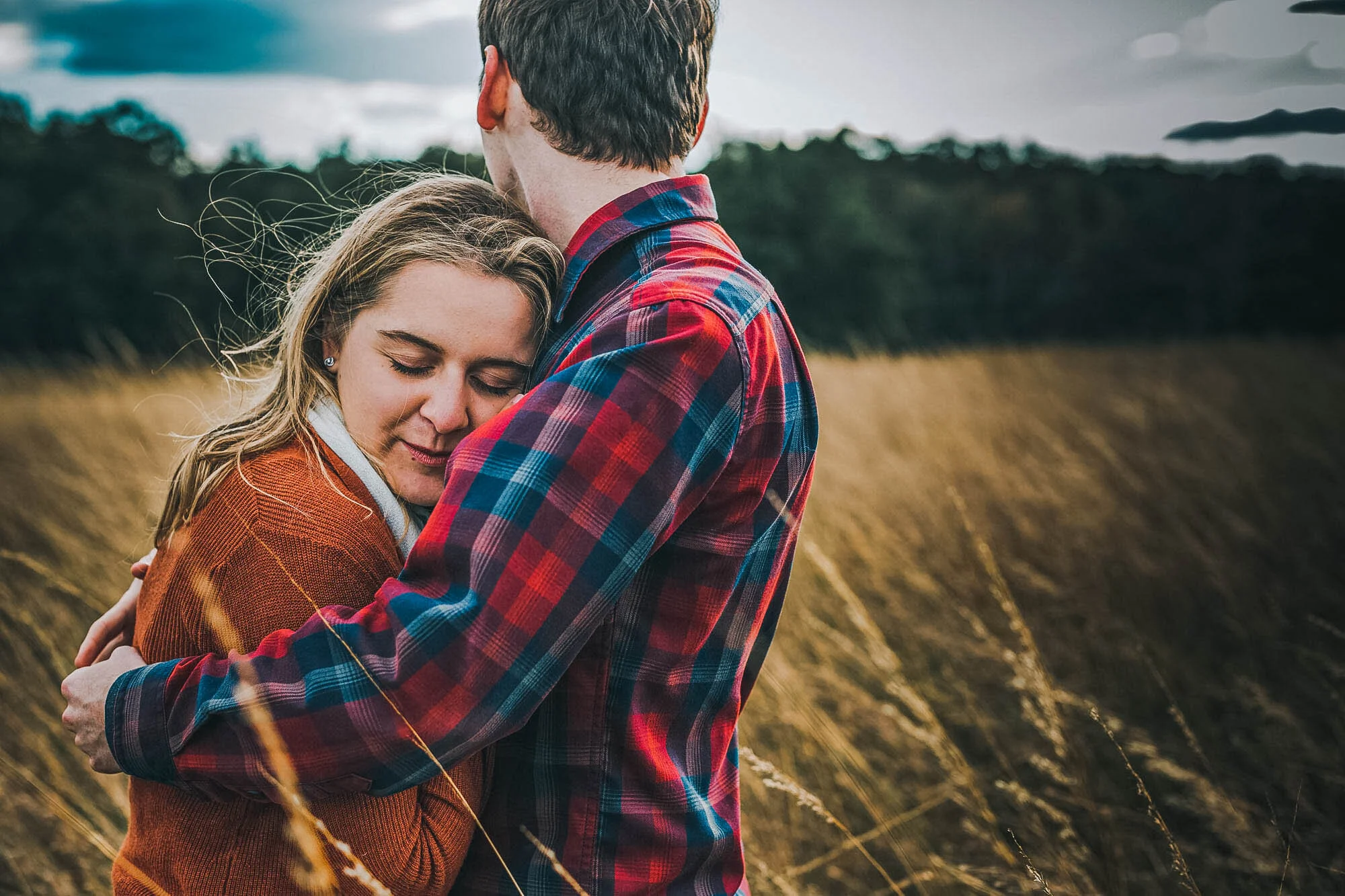 couple hugging in a winter field.jpg