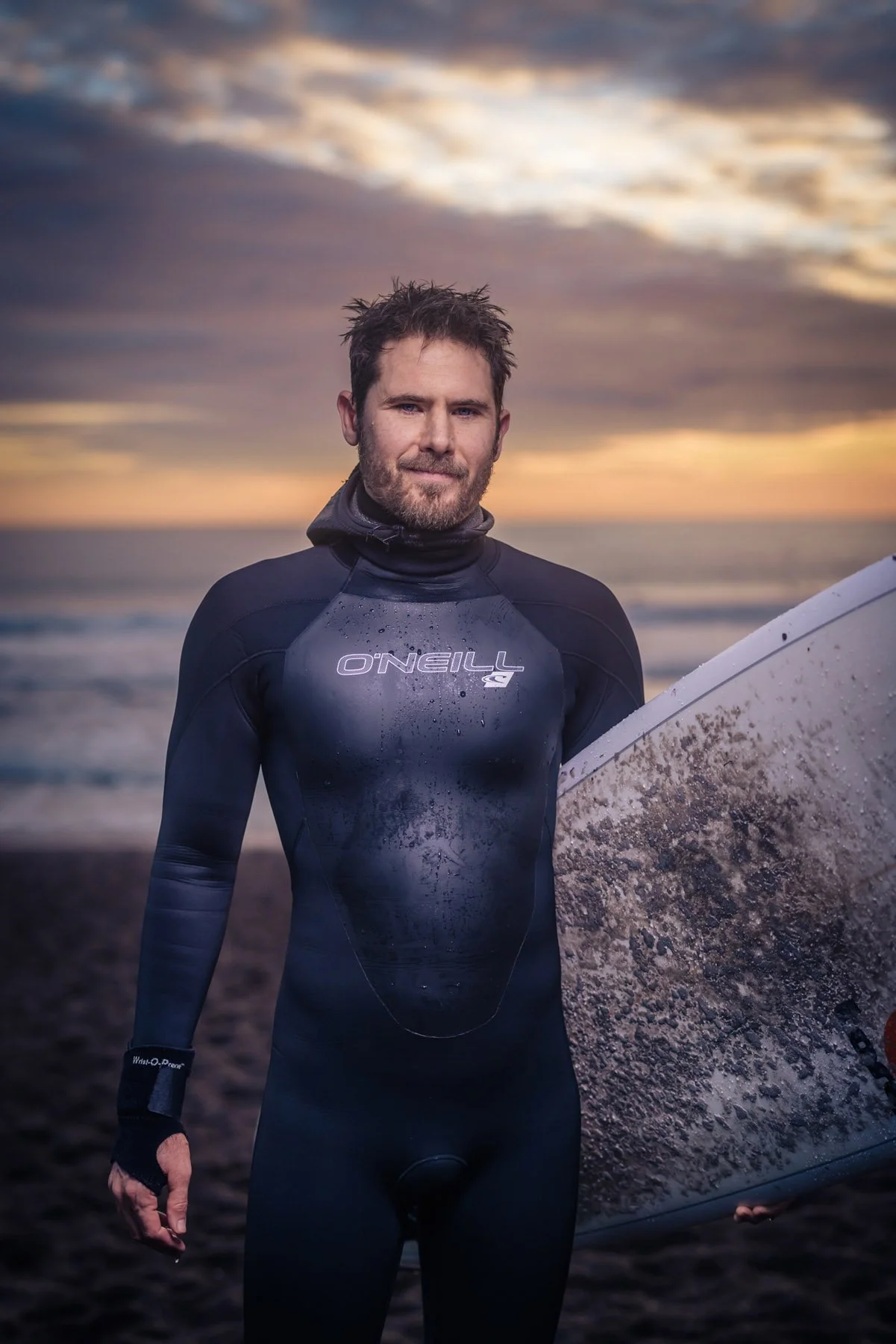 Man in wetsuit with surfboard
