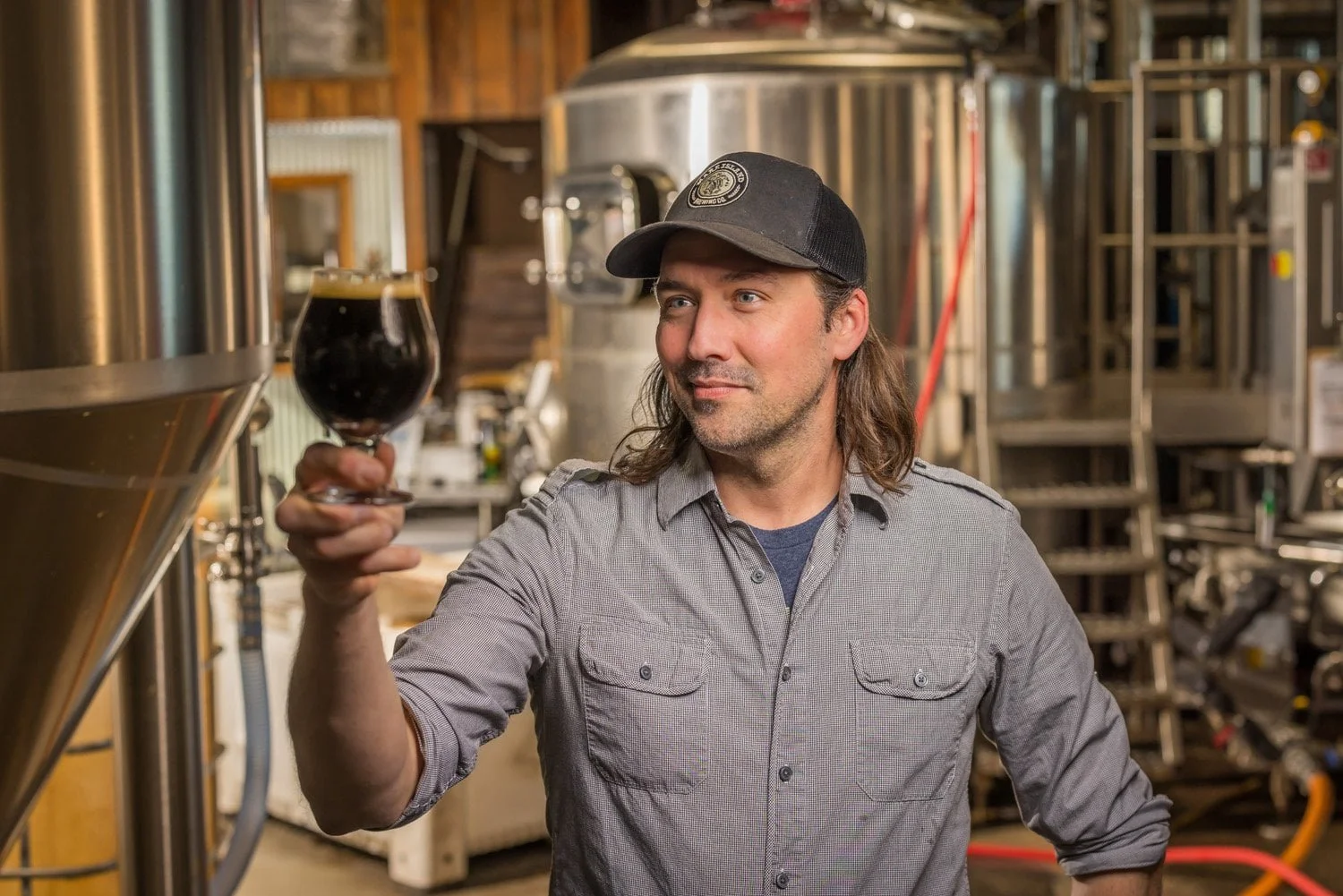 Brewing manager holding a glass of beer
