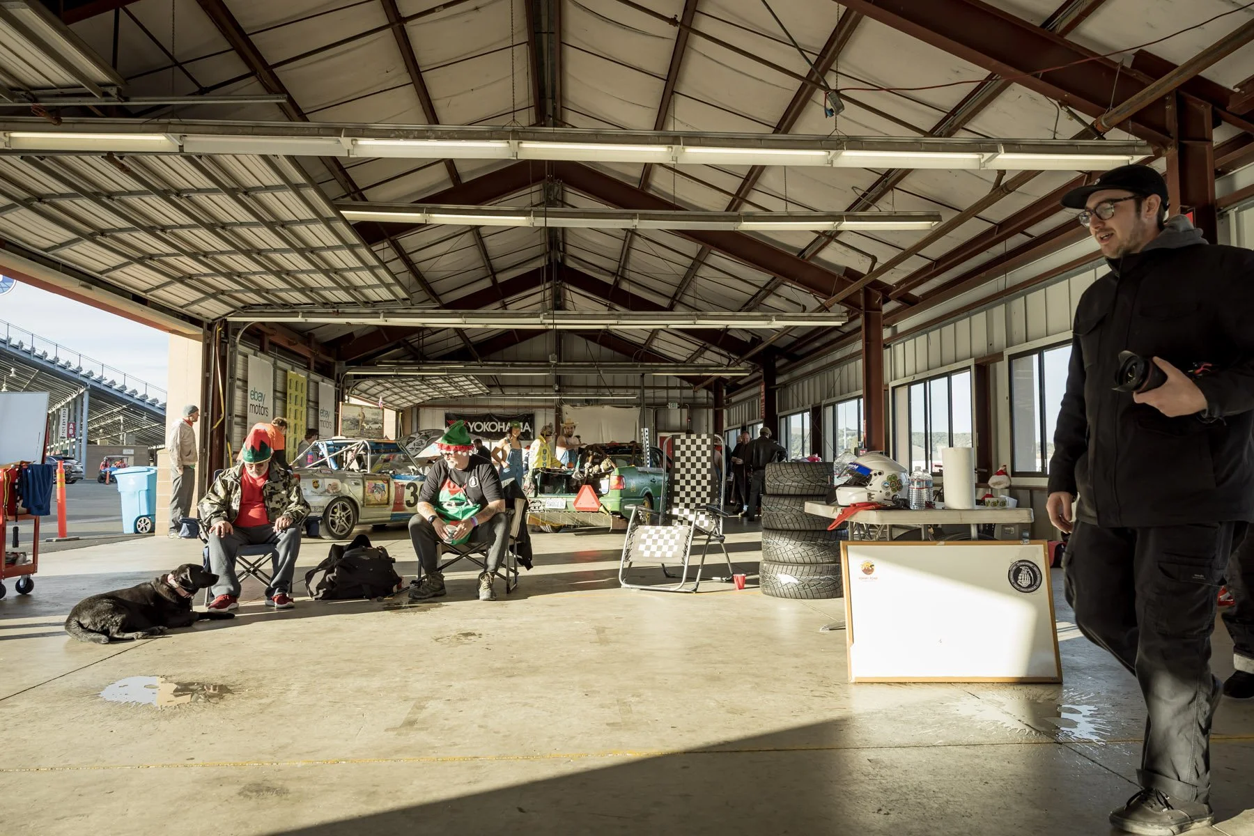 Industrial Photographer Richmond - People relax and work in a sunlit garage—race car, tires, and gear shine in every shot by Industrial Photographer Richmond.