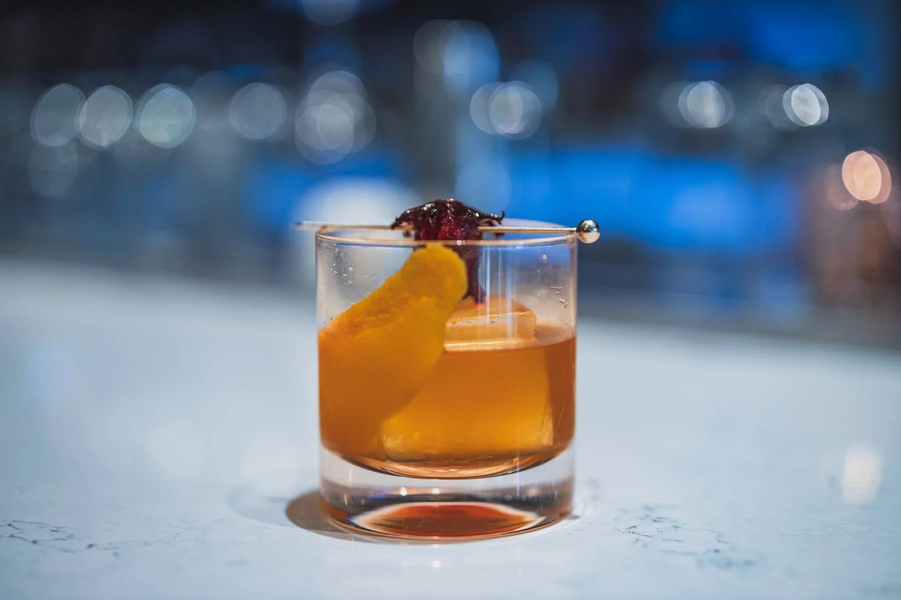 Product photography of a mixed drink on a restaurant bar