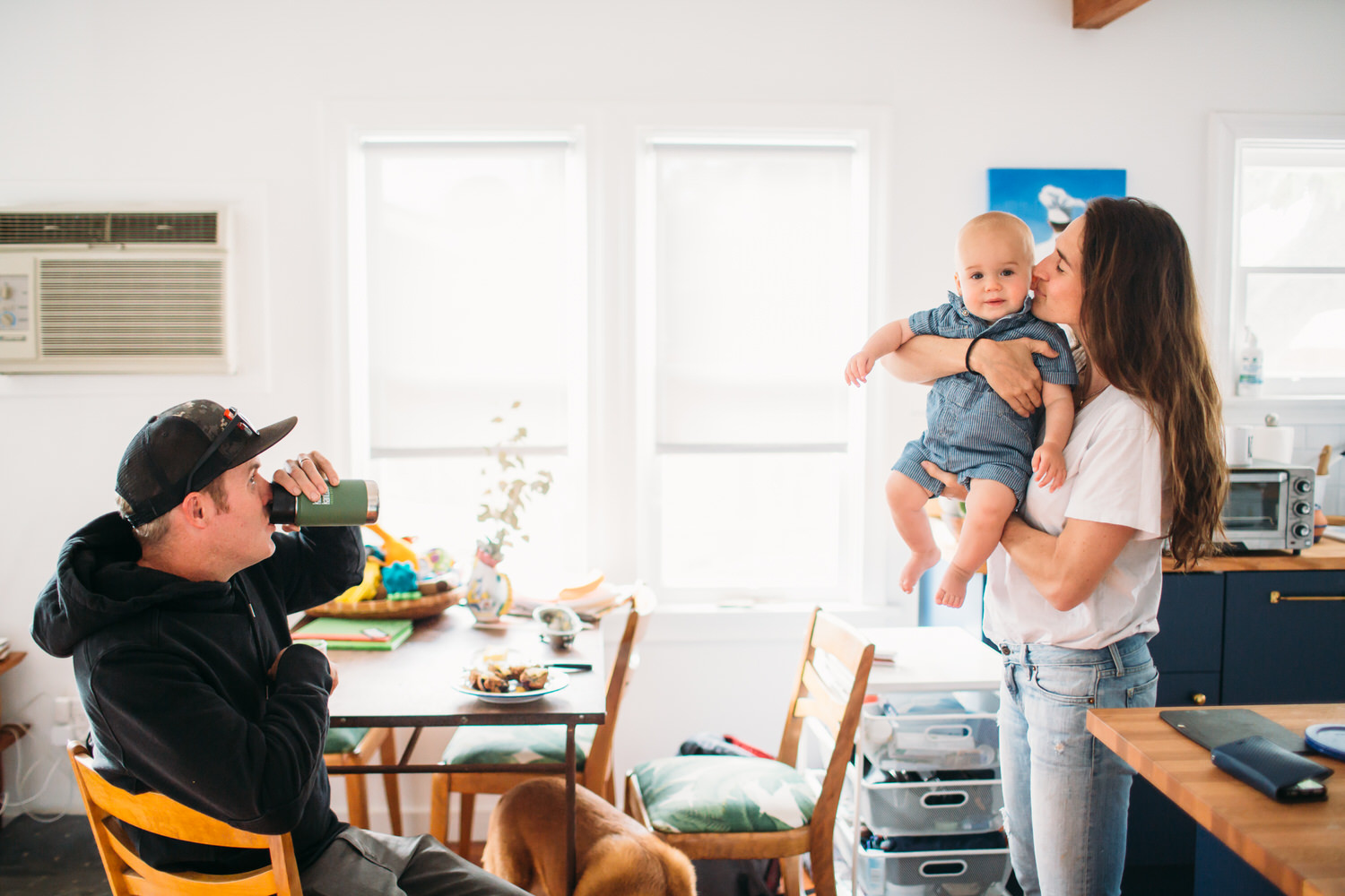 Family of three at home in Los Angeles in a bright white kitchen