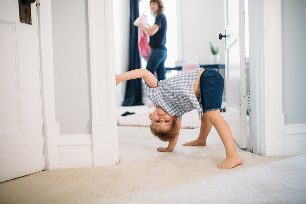 family photography Chicago, natural lifestyle photographer, boy being silly, boy doing cartwheel
