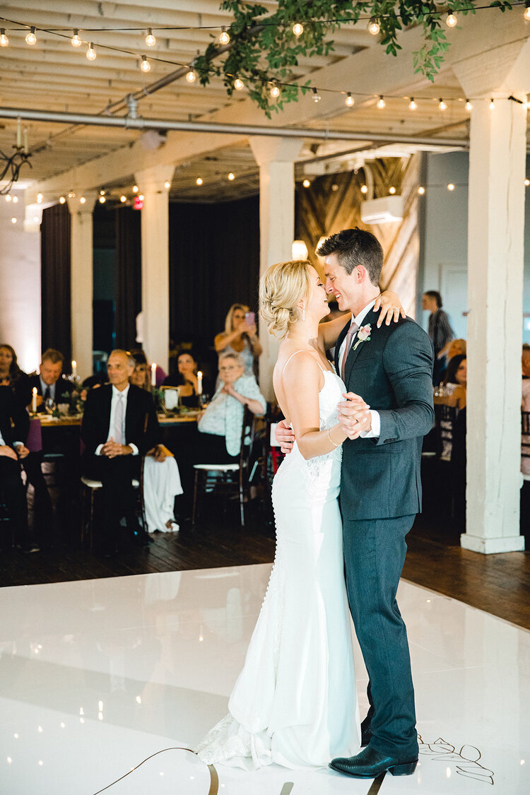 bride and groom first dance on monogram dance floor created by pink champagne designs