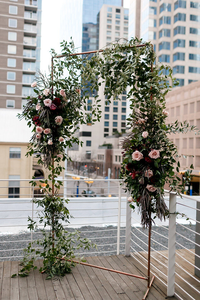 pink champagne designs wedding floral ceremony arch.jpg