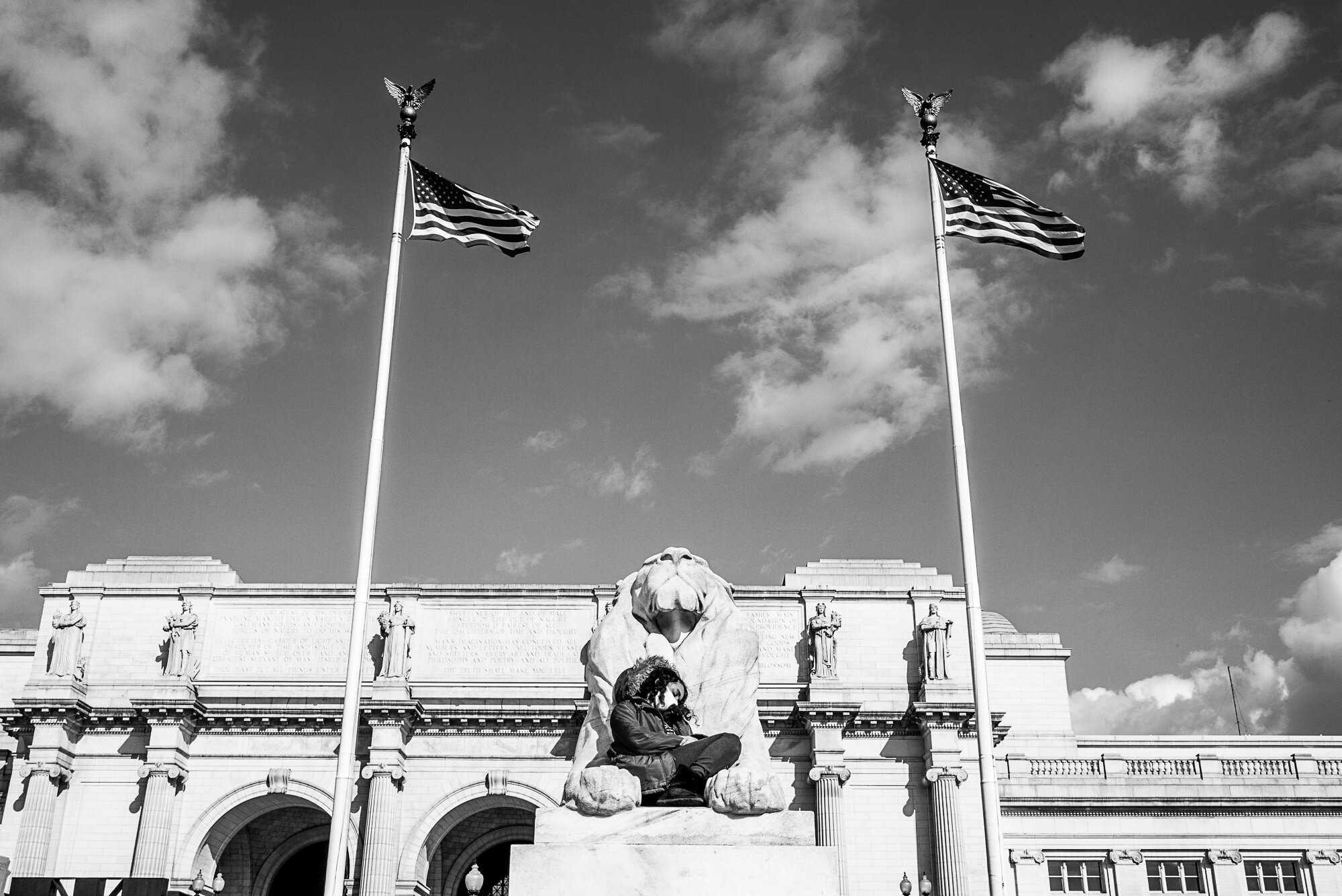  Woman sitting on lion at Union Station during Joe Biden’s Inauguration. 