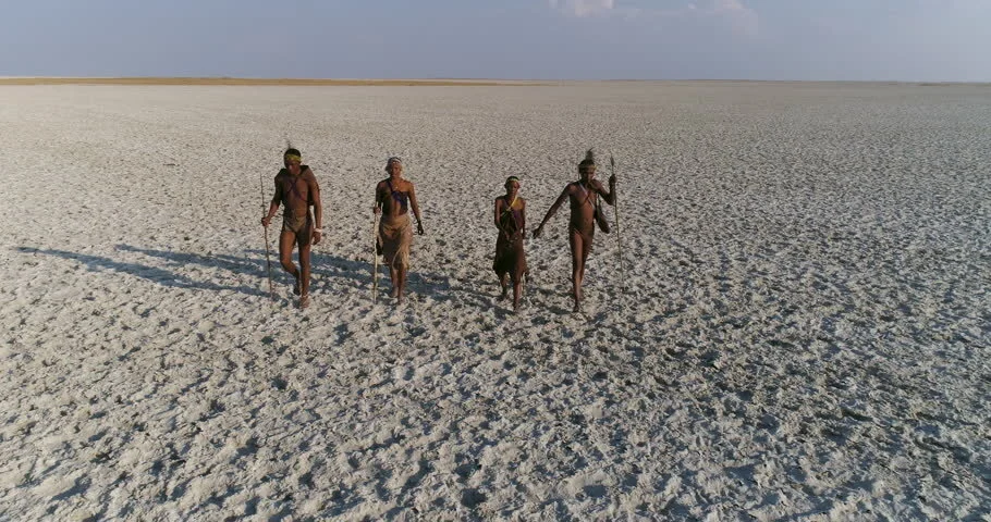 Bushmen walking across Makgakgadi