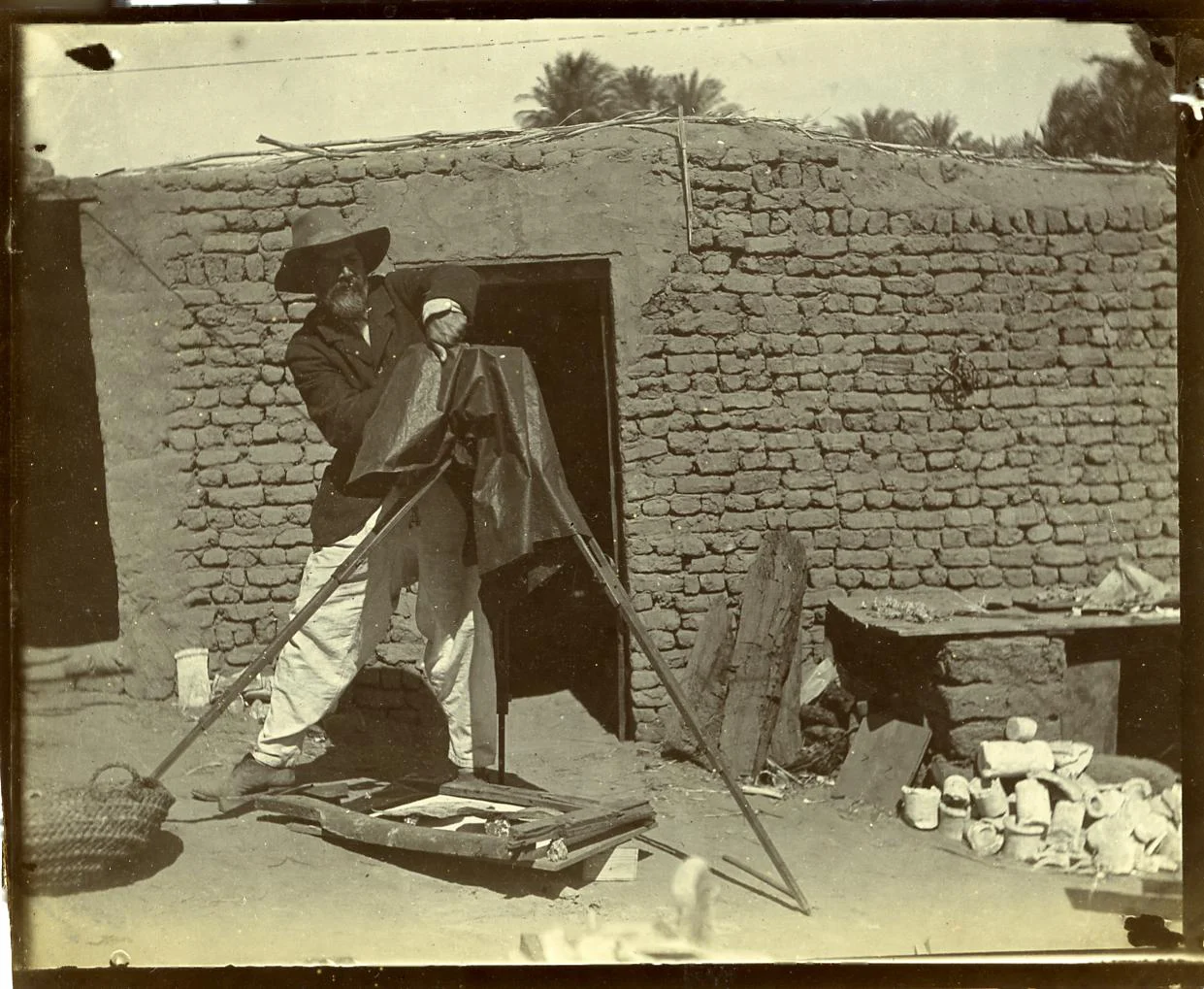 Fig. 10. Often called the “father of archaeology” for his pioneering field methods and attention to small and fragmentary artifacts, Flinders Petrie — seen here at Abydos in 1899 — was never far from a maqtaf like the one pictured here at his feet (lower left). Photo courtesy of the Petrie Museum of Egyptian Archaeology © UCL