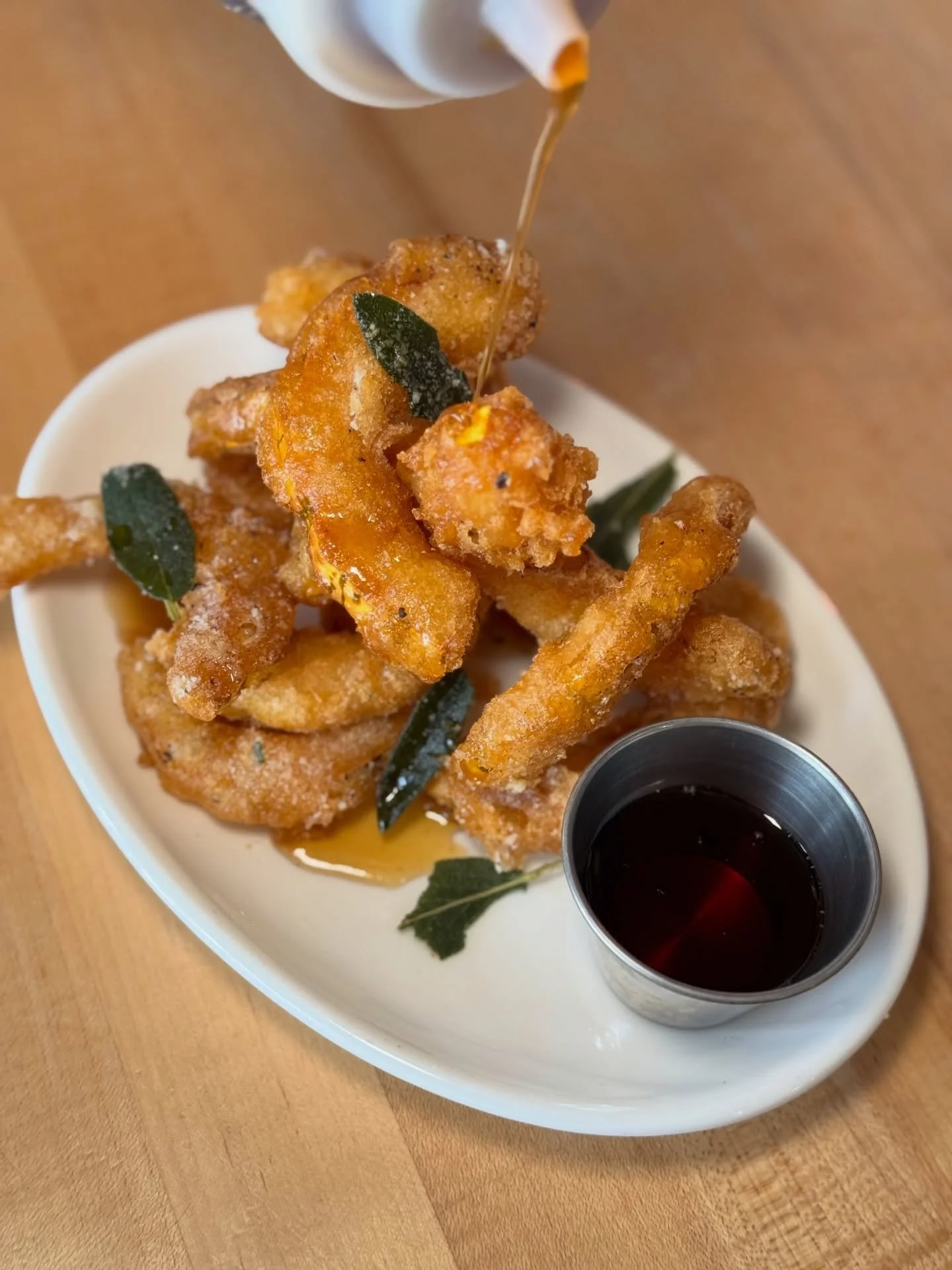 Crispy on the outside, cozy on the inside! 🥰 Our delicata squash fritters are topped with fried sage, pecorino, and finished with a dreamy maple syrup drizzle! 🍁✨

Honestly, maple drizzle never looked so good! 😍
Come treat yourself, we&rsquo;re op