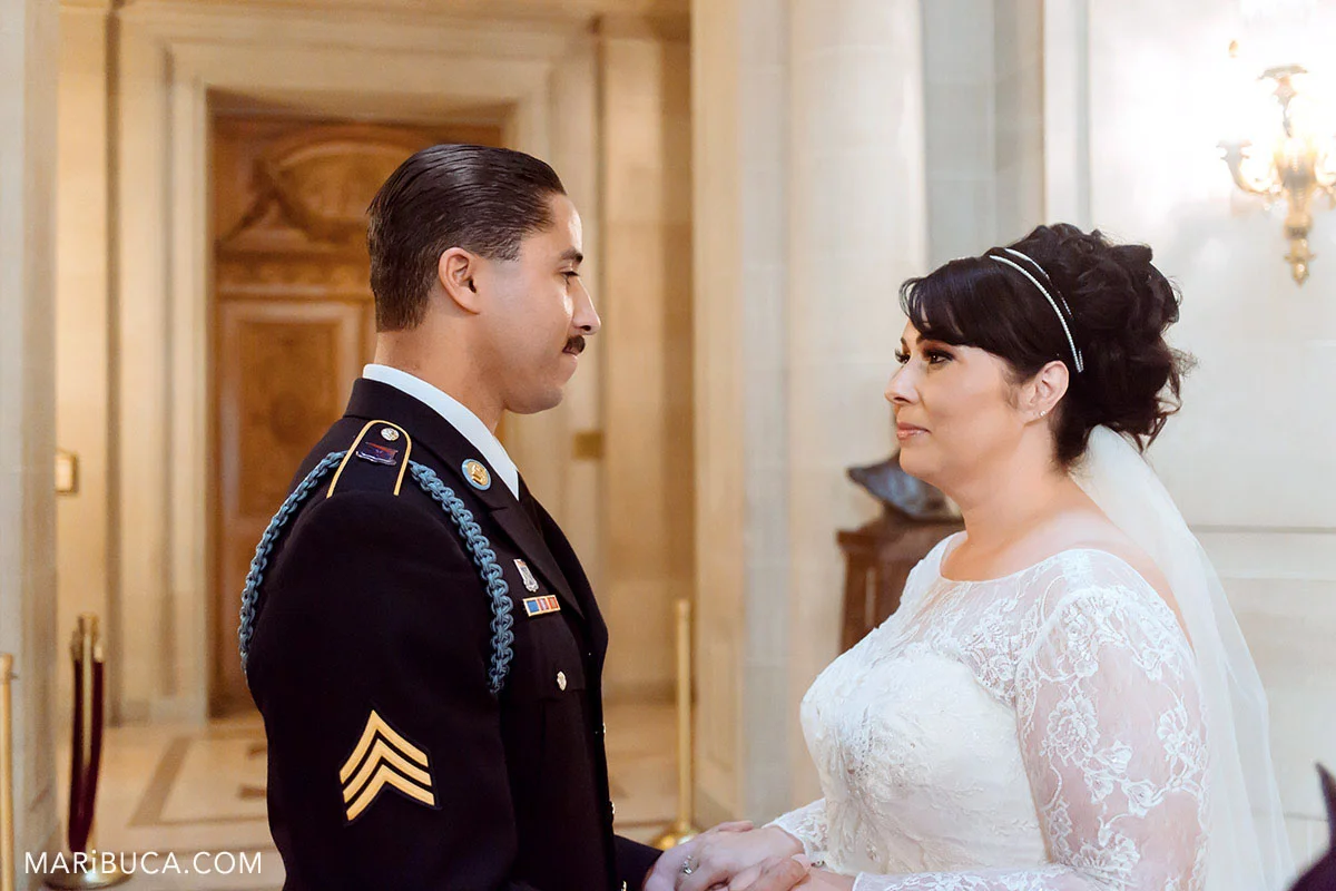 the groom and the bride look each other in the ceremony SF CIty Hall