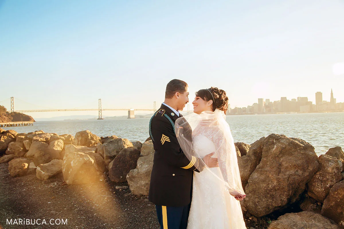 the bride and the groom look each other in the Treasure Island during sunset time.