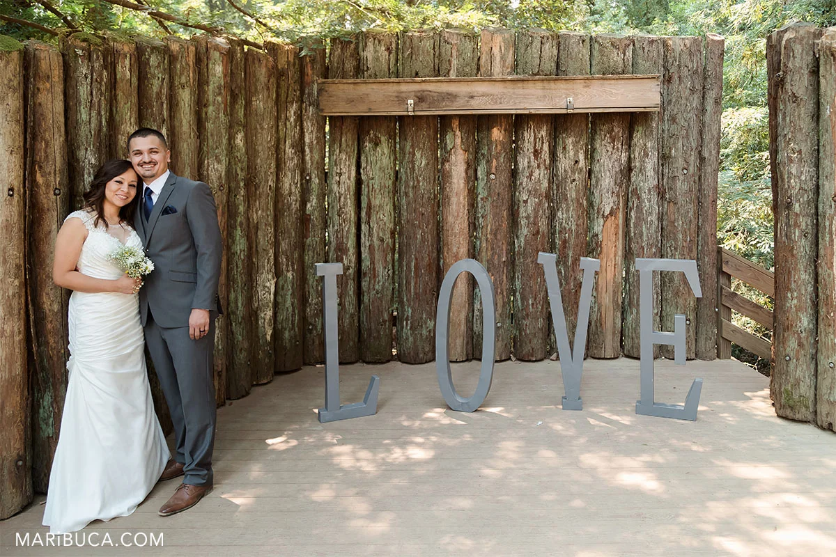 Love sing as the background and married couple after ceremony in the Watsonville
