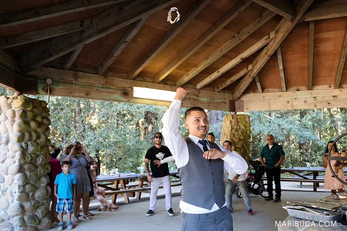 the groom throws the garter to groomsmen