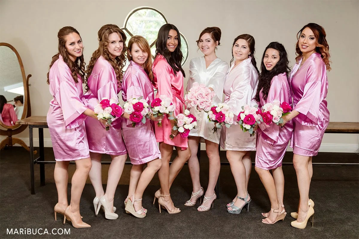 7 bridesmaids in the rose robes, and the bride before ceremony in the Wente Vineyards.