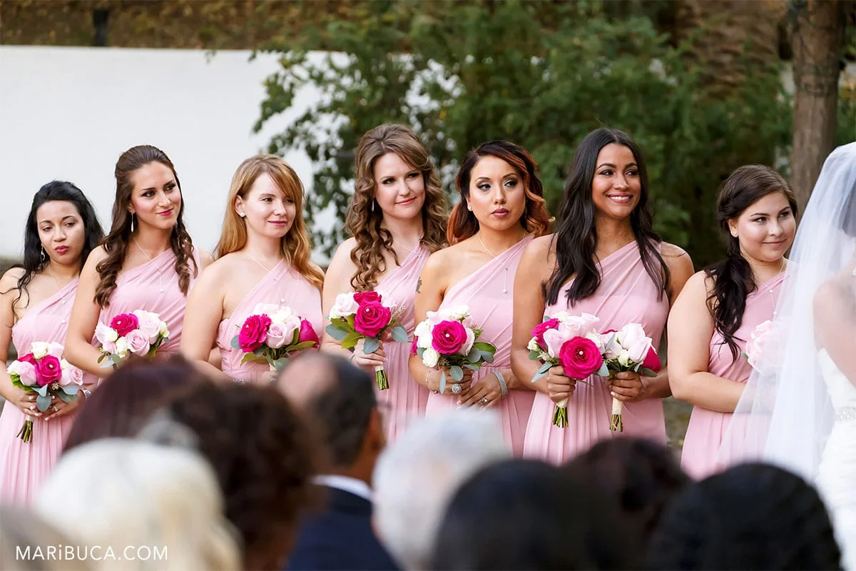 7 bridesmaids looking at the bride