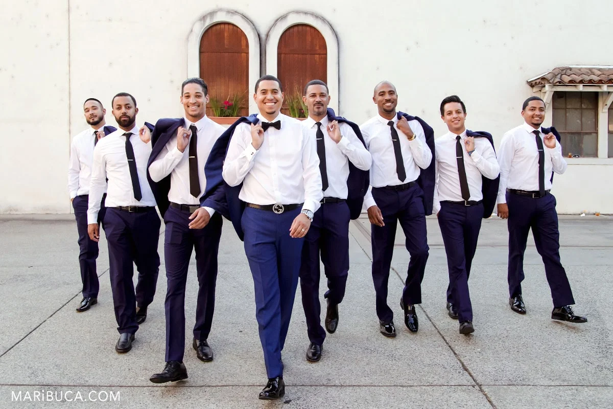 The groom and groomsmen have walking in the vineyards.