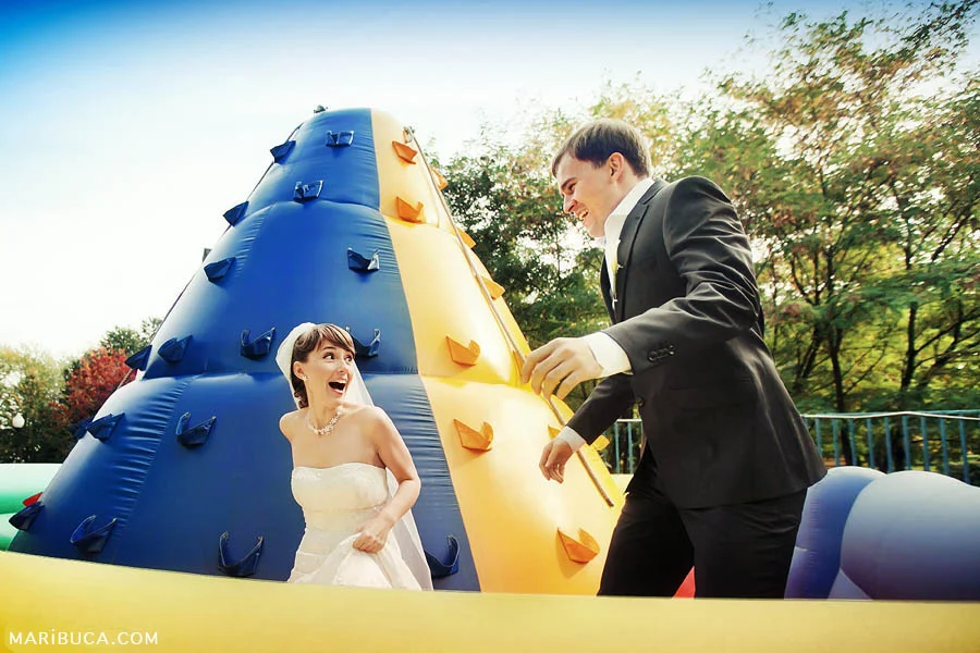 bride and groom at an amusement park on their wedding day