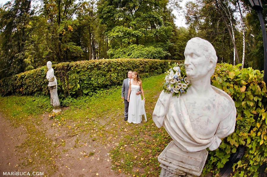 the bride and groom embrace each other and look to the future, and on both sides there are monuments.
