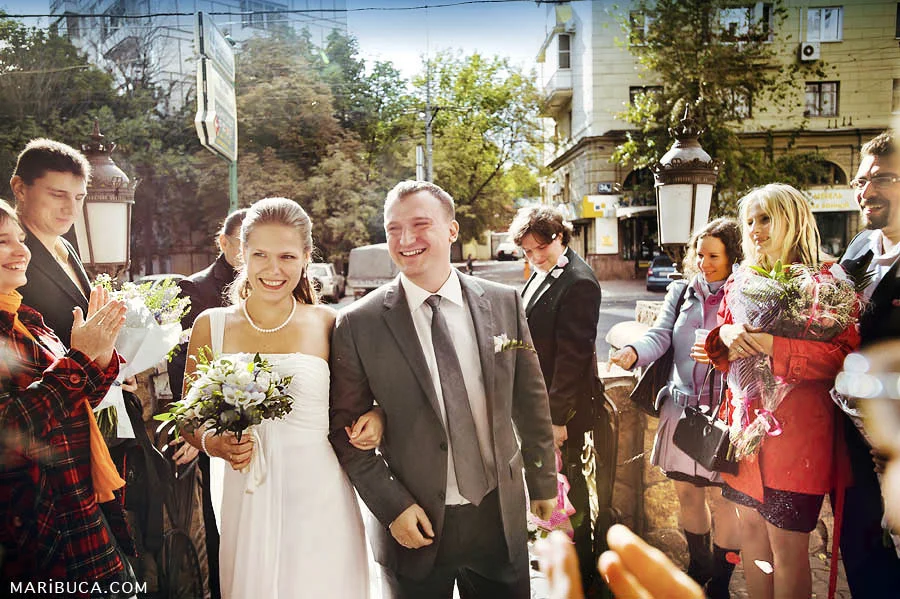 Guests meet newlyweds in front of the reception.