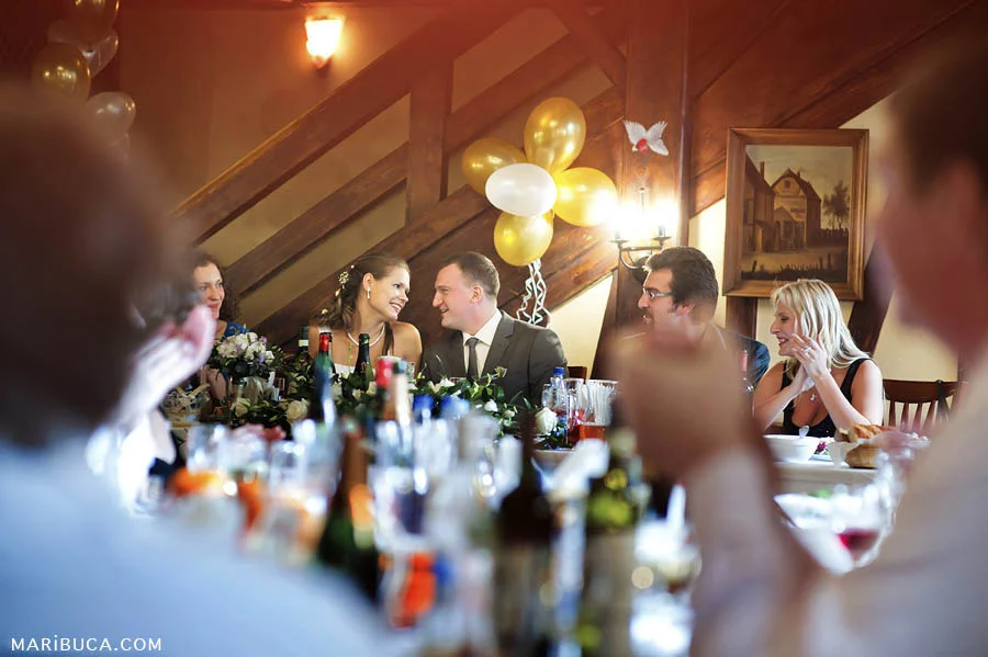 Bride and groom enjoy each other company and around their family and friends.