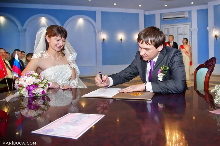 the groom signs the marriage registration hall