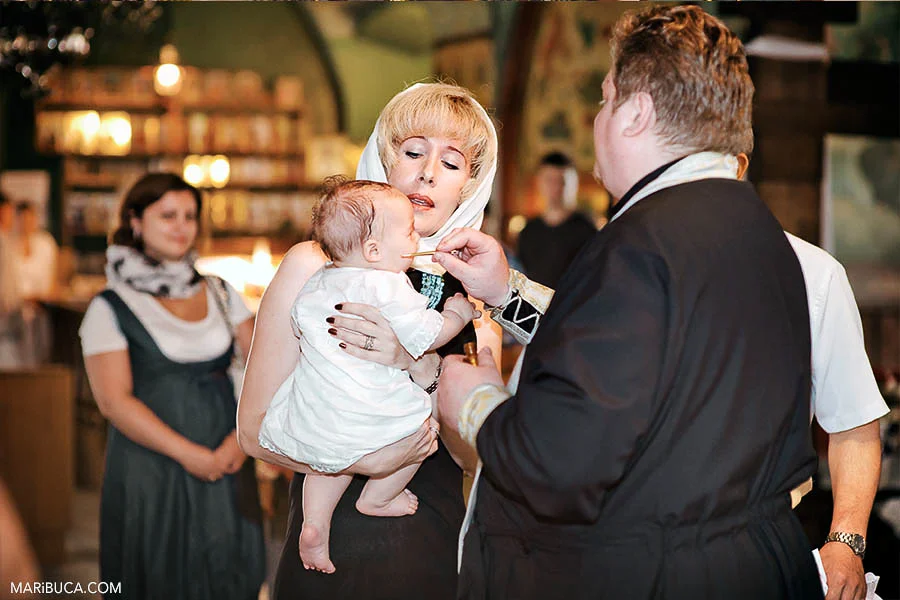 christening-church-baby-boy-priest-traditional-moment