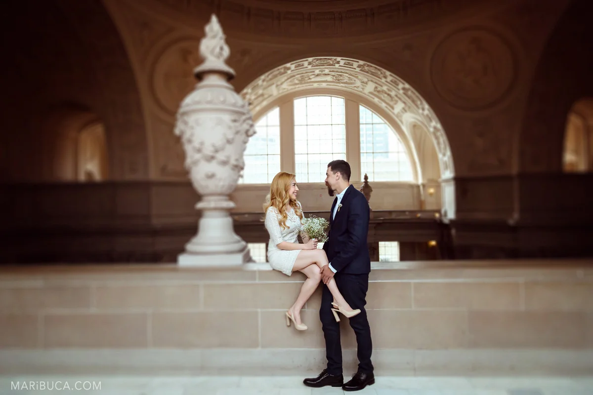 The groom and the bride are looking each other in the adorable place in the 4th floor San Francisco City Hall