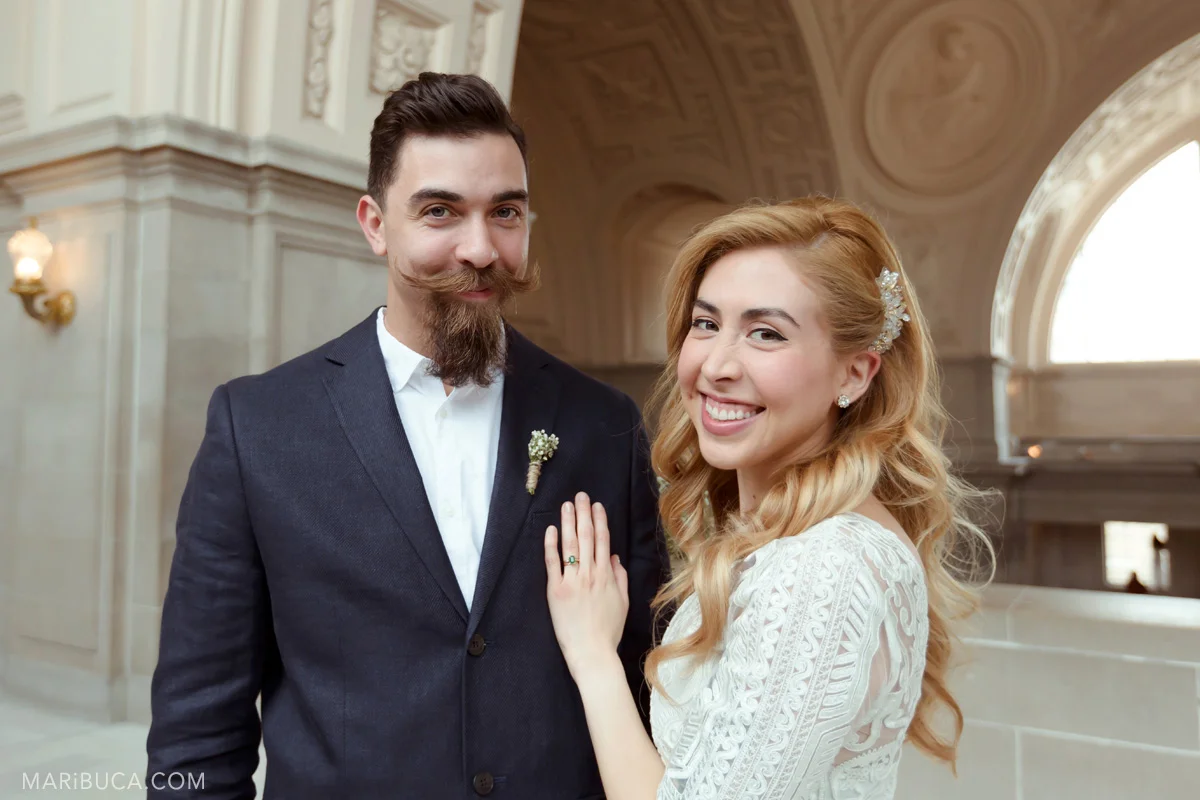 The bride and groom have a big smile! They married in the SF City Hall