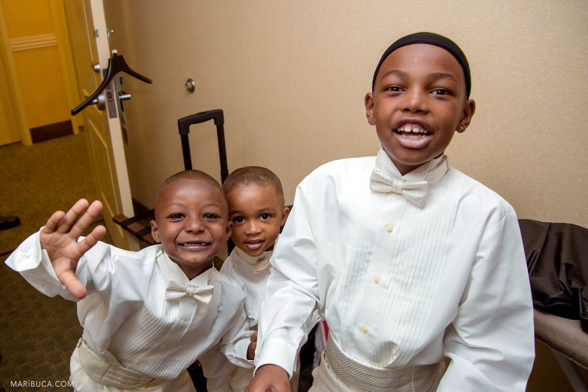 Happy kids in the wedding during getting ready in the groomsmen room