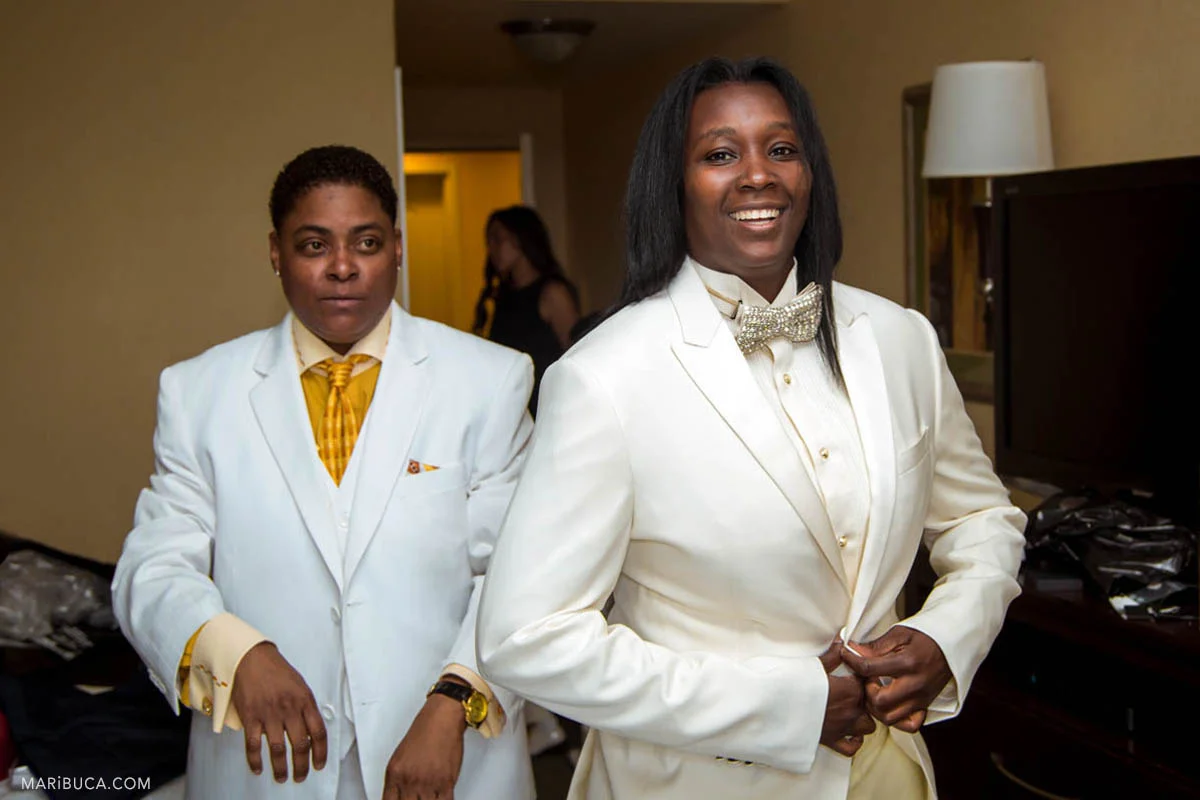 The groom is wearing the white jacket as well as the groomsmen as the same sex wedding during getting ready in the hotel