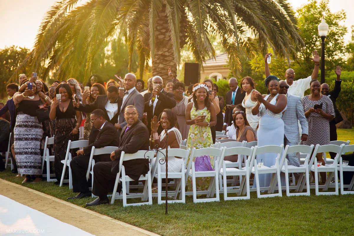 Guests happy to see the groom and wedding party in the Newberry Estate Vineyards.