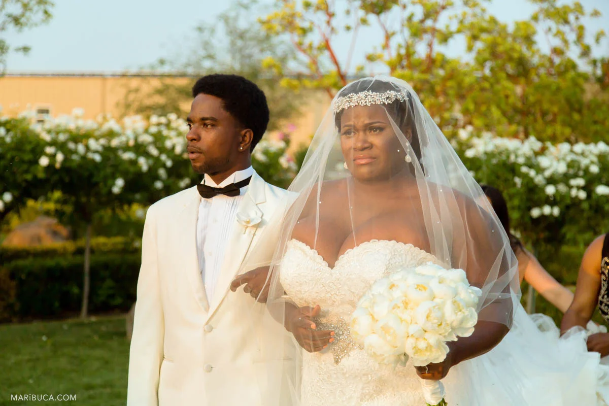 Bride and her brother are walking down the aisle in the Newberry Estate Vineyards.
