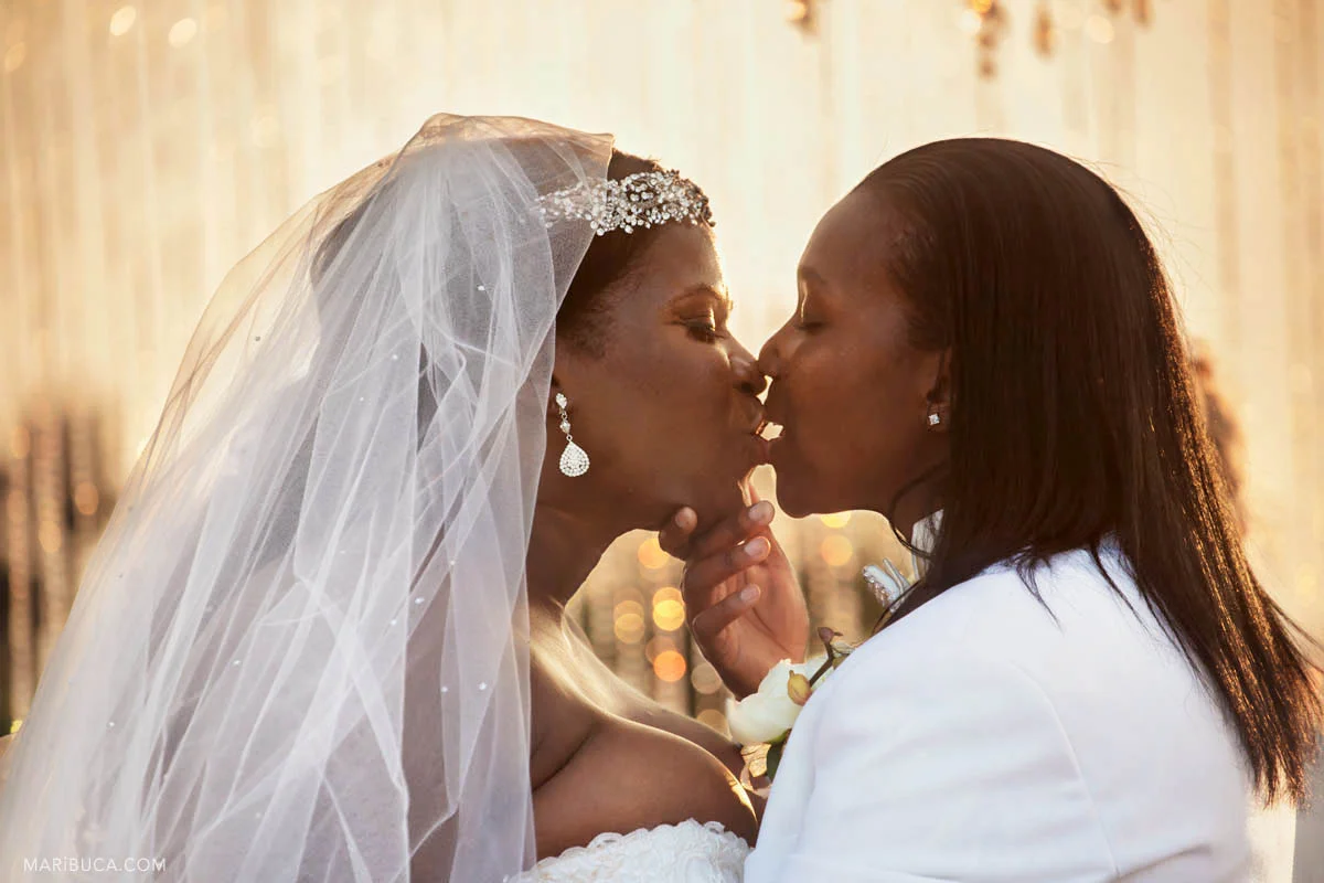 Two brides have the first kiss as married couple in their wedding ceremony..